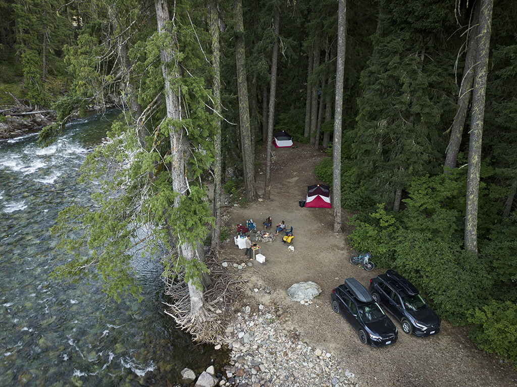 birds eye view of car camping spot next to river