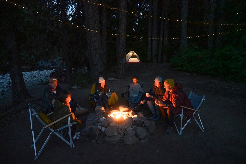 group around campfire at night