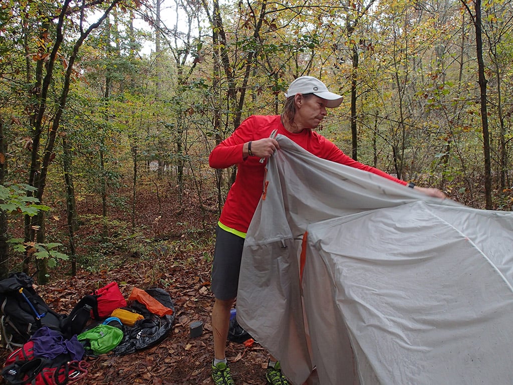 setting up tent on ultralight hike
