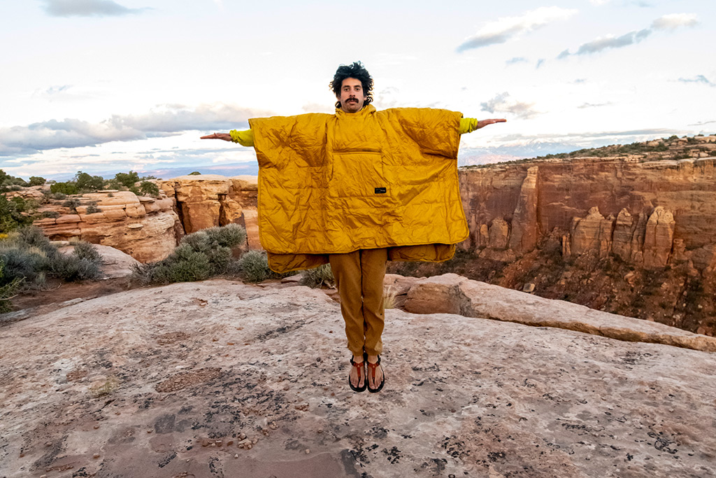 Man jumping in honcho poncho in the desert