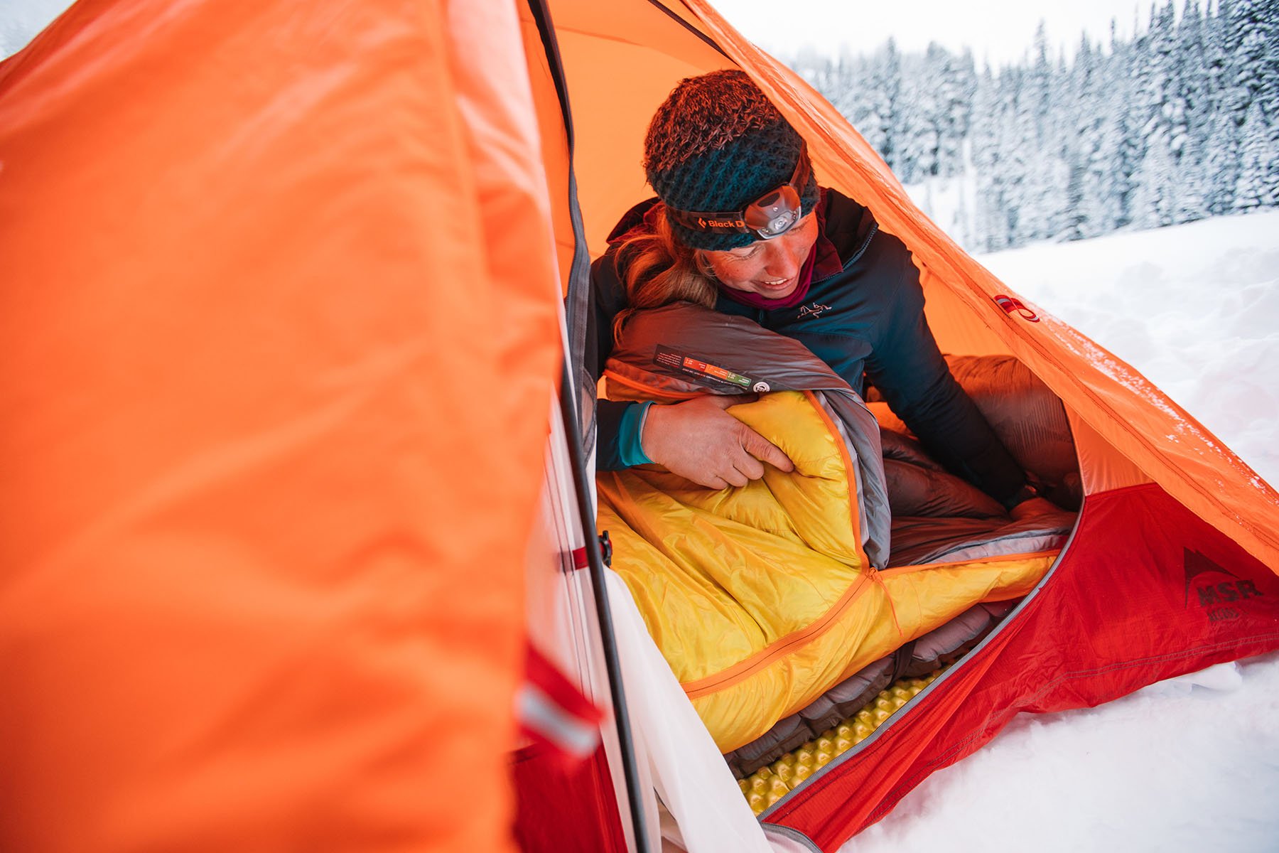 sitting in tent in winter sleeping bag