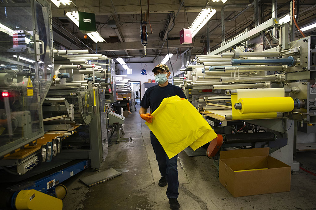 carrying raw sleeping pad materials in manufacturing facility