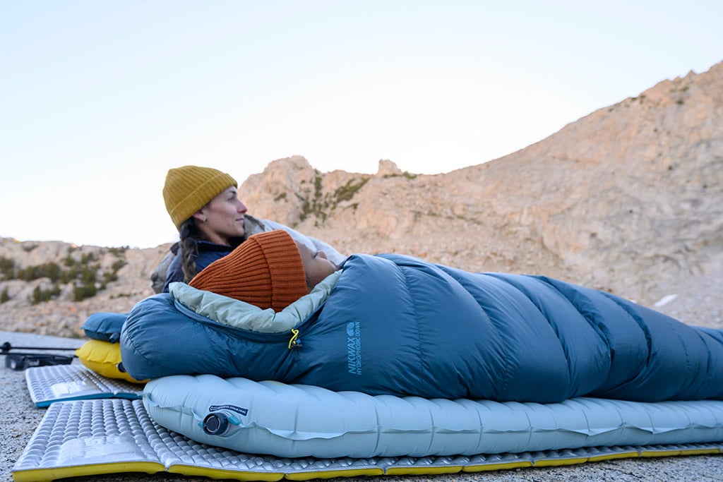 two people lying down in complete sleep systems