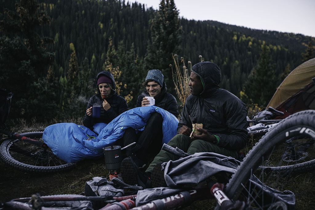 bikepacking team eating at camp