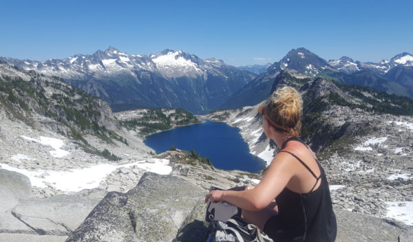 Woman sitting overlooking glacial lake