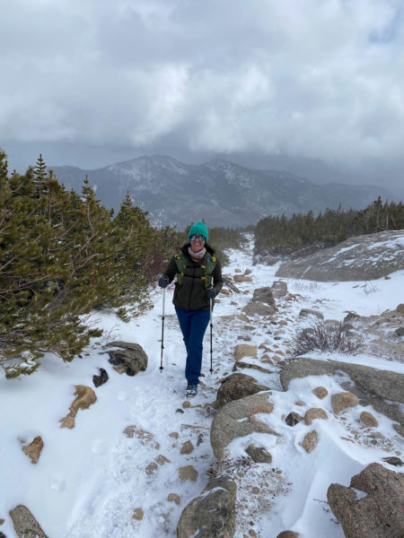 using trekking poles to hike in national park during winter