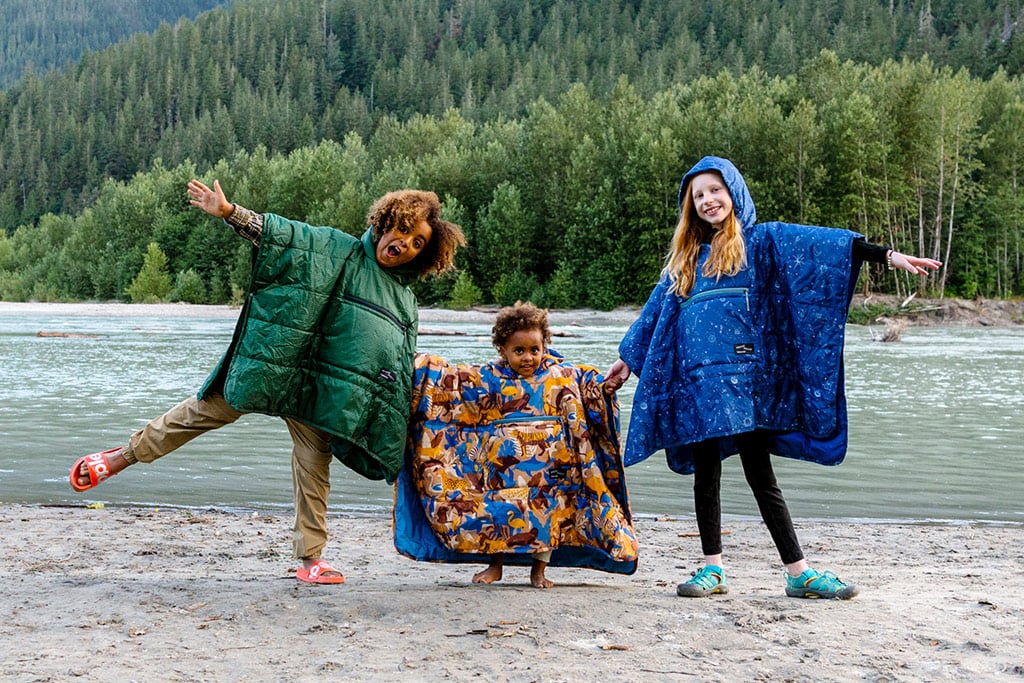 Three kids wearing the Therm-A-Rest Honcho Poncho Kids prints